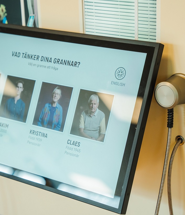 En bildskärm med fotografier på personer och rubriken "Vad tänker dina grannar?".